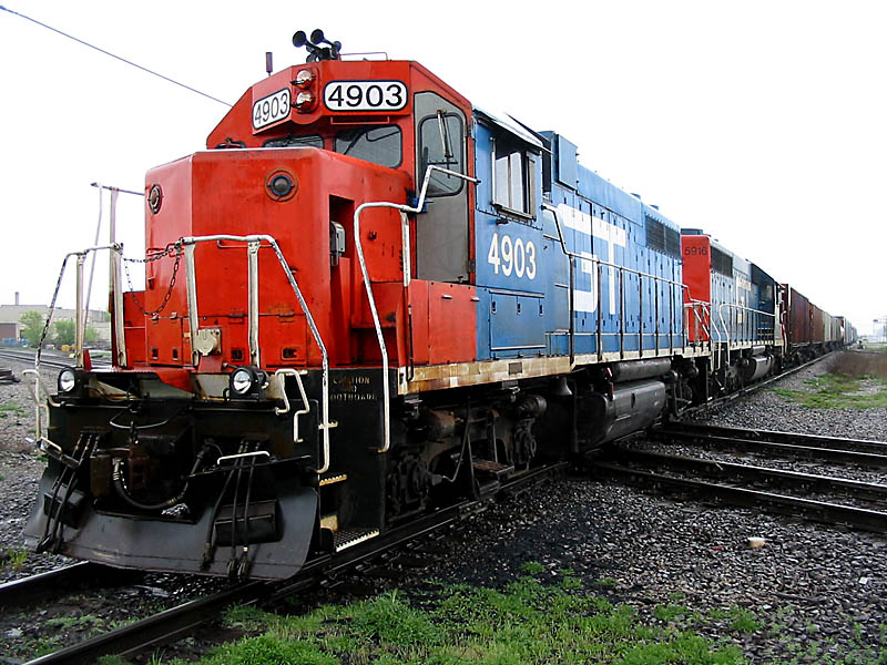 GT 4903 & GT 5916
GT #4903 and GT #5916 backup into the Durand Yard on another local from Flint. They posed in front of the station on the diamond for a while. 05/01/04 
