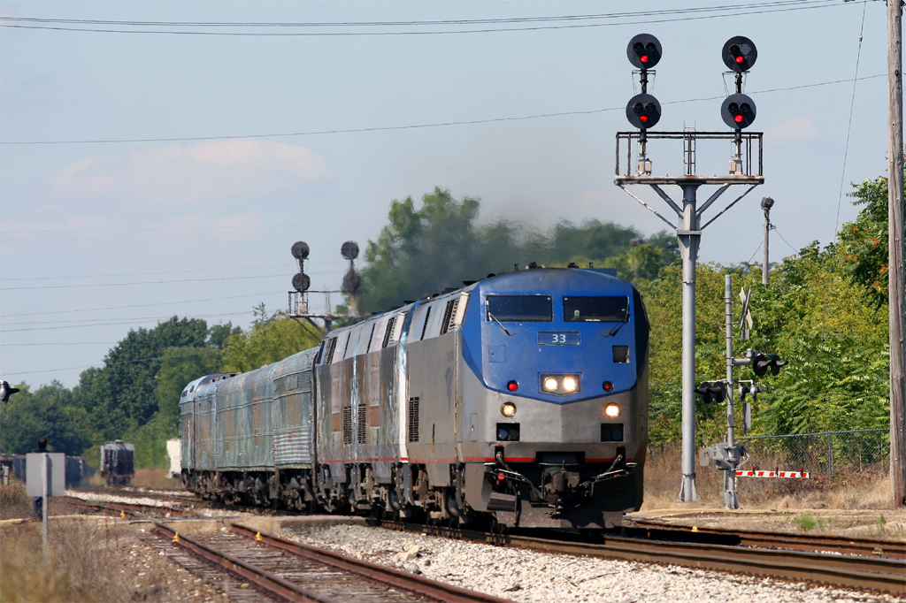 The Disney Christmas Carol Train Tour!
Amtrak special 932, headed by ITCS-equipped P42 #33, heads east through CP-Albion in Albion, MI on the NS Michigan Line. The train is none other than Disney's Christmas Carol promotional tour, heading for a labor day stop at the Henry Ford in Dearborn, MI. Note the bracket mast style Tri-Light signals at the right - a rarity in Michigan. The Michigan Line heralds three of only about five of this style of the signal, the other being at CP-East Jackson.
9/3/09
