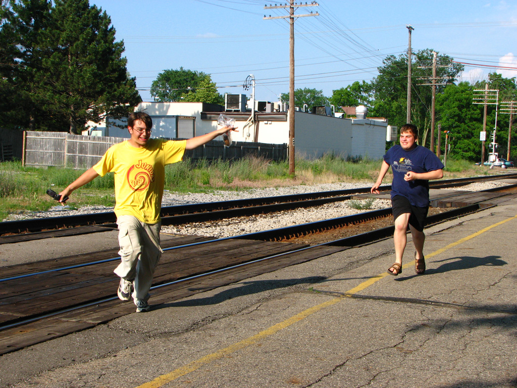 Gregg chases cam who has greggs donut.
