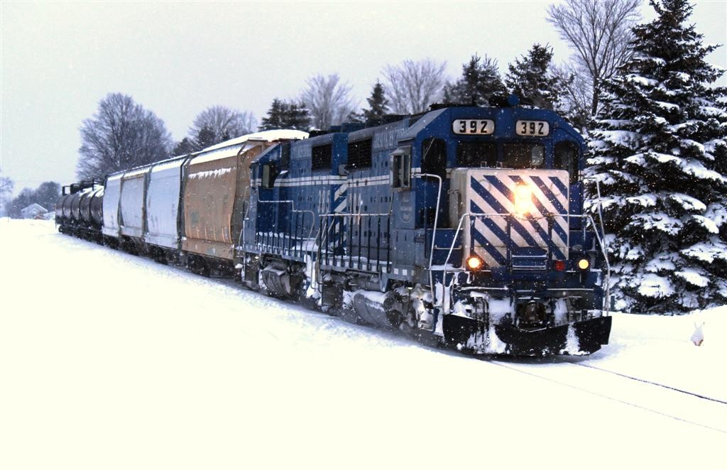 GLC 20 Jan 2016
Done working the siding at Mancelona, and with UTCX 54515 added to her train, GP35's 392-385 depart town headed for Kalkaska.
